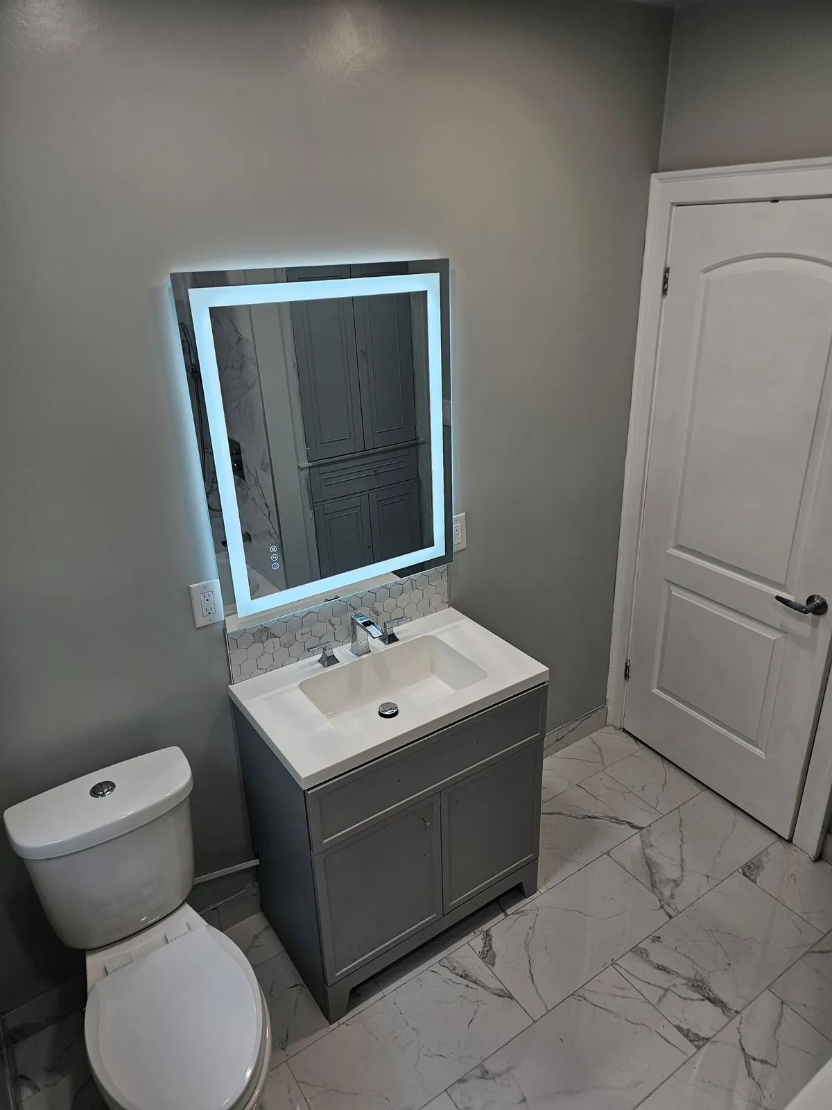 Backlit mirror & gray vanity